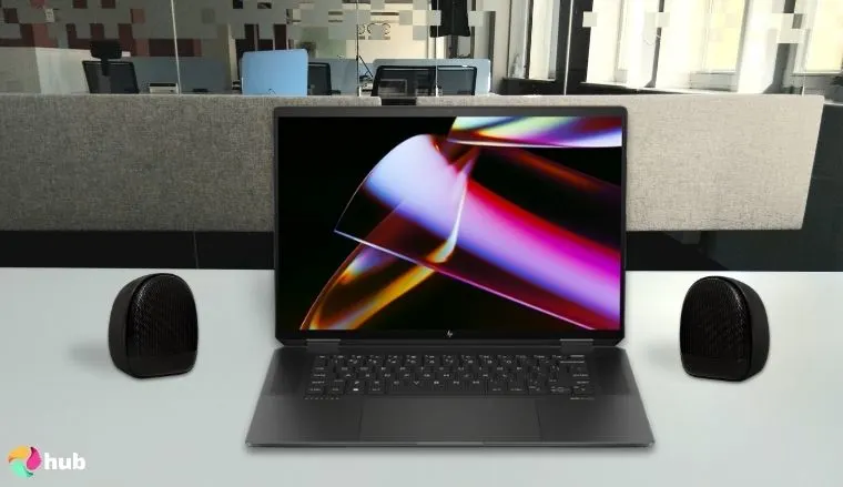 HP Spectre x360 AI-Powered 2-in-1 Laptop on a white office desk with natural shadows for a review