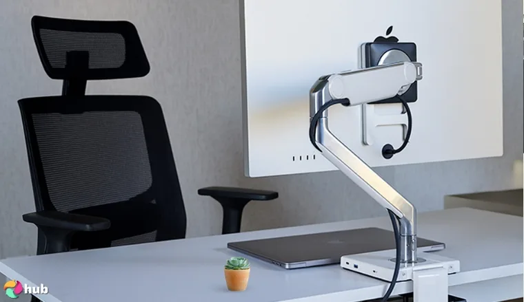 Humanscale M2.1 Adjustable Monitor Arm on a white office desk in close-up for a review