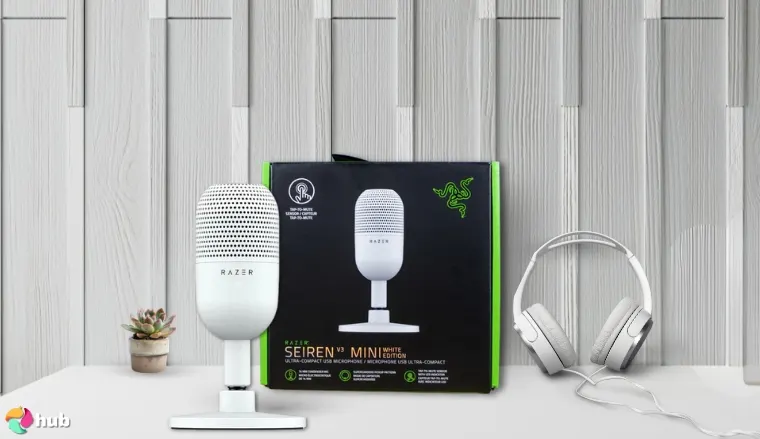 Razer Seiren V3 Mini Microphone on a white office desk in a top-down view for a review