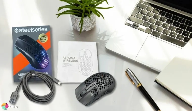 SteelSeries Aerox 3 Mouse on a white office desk in a clean setup for a review
