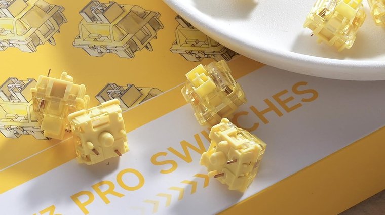 Akko V3 Creamy Yellow switches scattered on top of their product box.