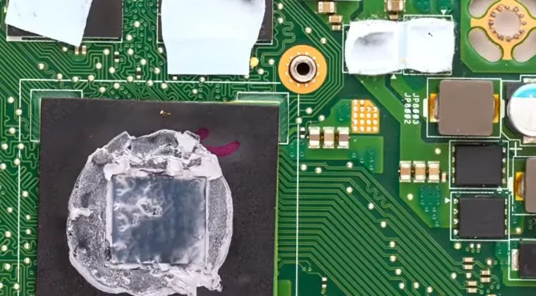 Damaged CPU motherboard area showing visible burn marks and broken components