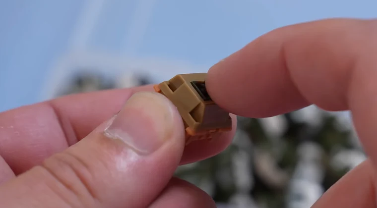 Close-up of a mechanical switch held in a person’s hand