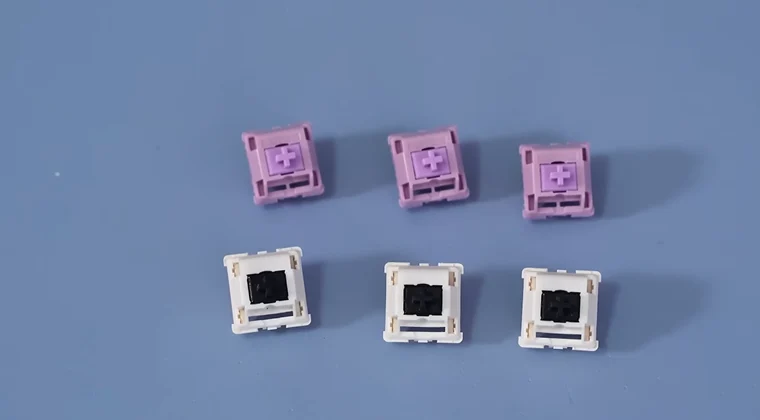 six mechanical keyboard switches on a table.