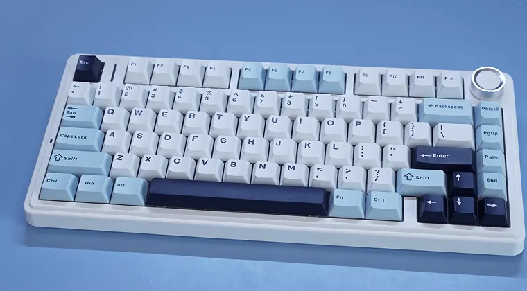 A light-colored keyboard placed on a blue background