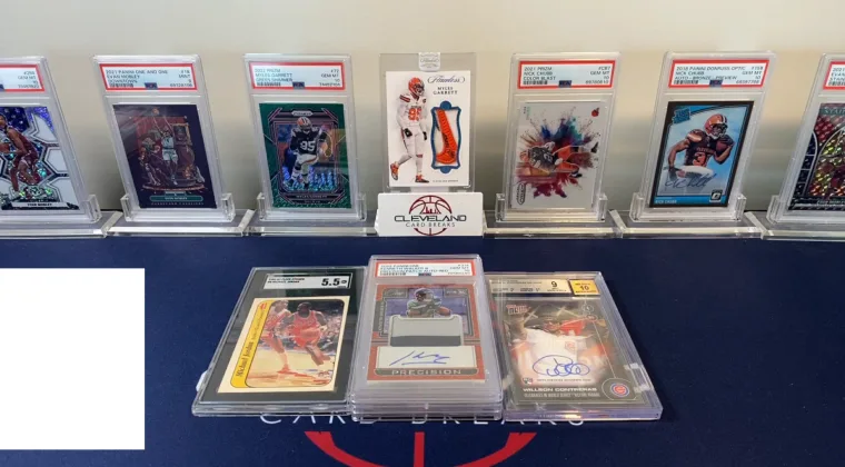 Several graded trading cards spread out on a table
