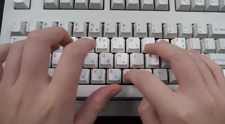 Fingers typing on a mechanical keyboard