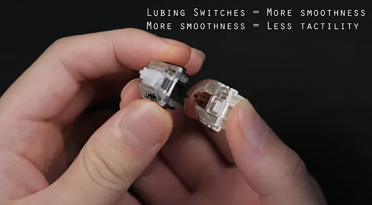 Close-up of two mechanical keyboard switches being held between fingers