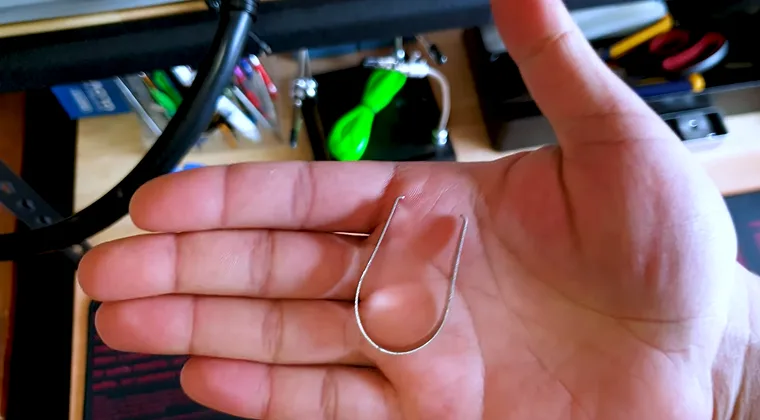 Close-up of a hand holding a keycap remover