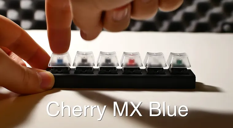 A finger pressing down on a mechanical keyboard switch