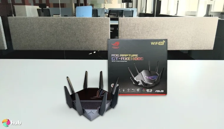 ASUS ROG Rapture GT-AXE11000 Wi-Fi Router on a white office desk prepared for testing shots