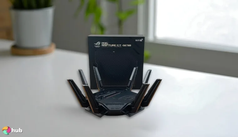 ASUS ROG Rapture GT-BE98 PRO Wi-Fi Router on a white office desk set up for testing and review