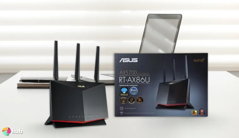 ASUS RT-BE86U BE6800 Wi-Fi Router on a white office desk styled neatly for a review