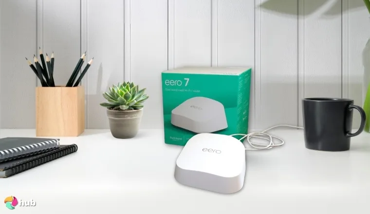 Amazon eero 7 Router on a white office desk with soft lighting for a review