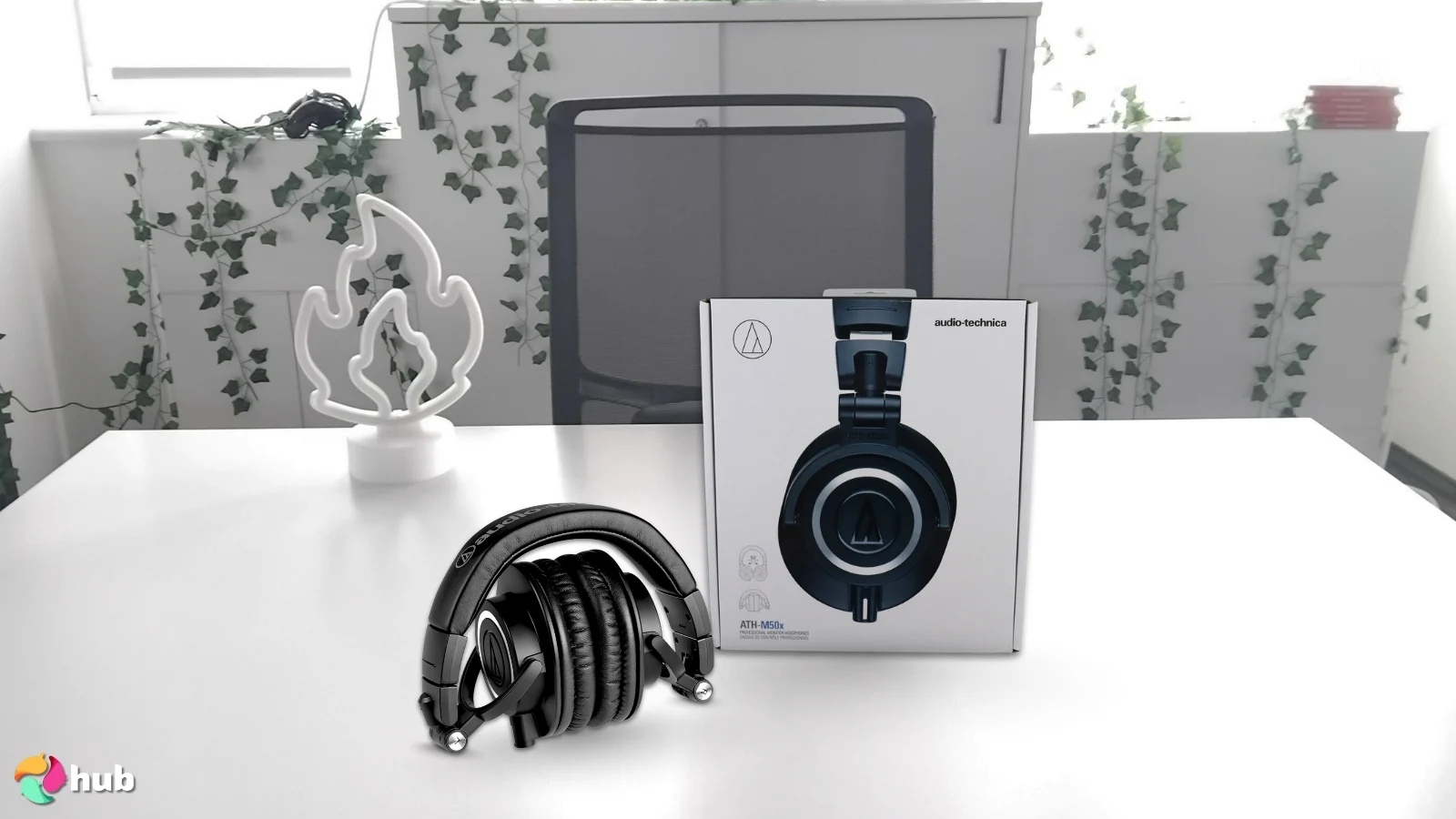 Audio-Technica ATH-M50X Headphones on a white office desk in a well-lit setting for a review