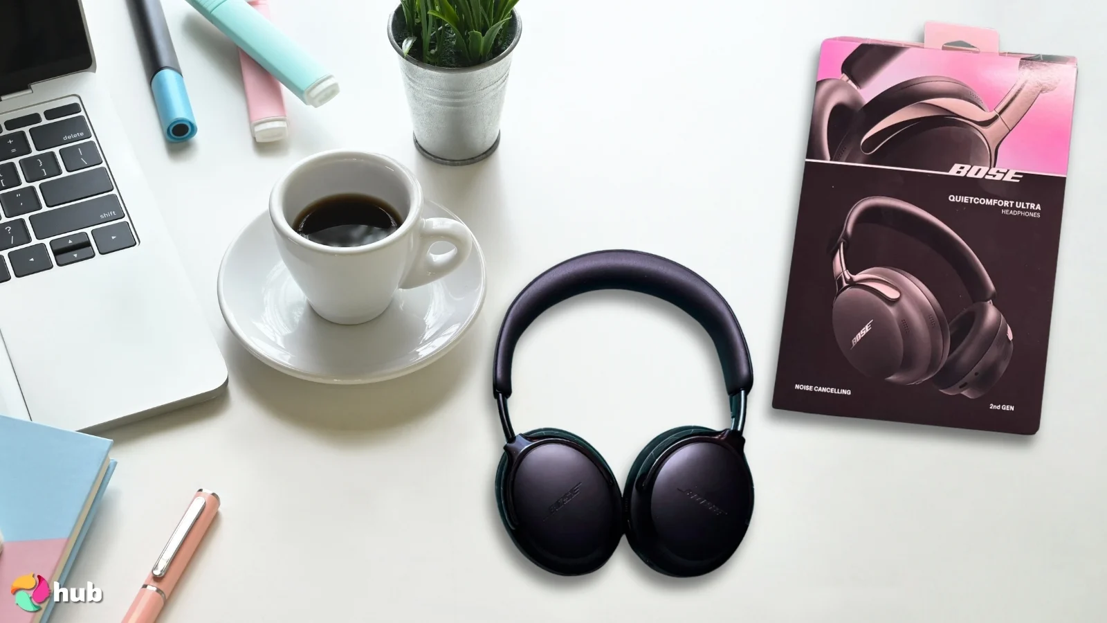 Bose New QuietComfort Ultra Headphones on a white office desk with creative arrangement for a review
