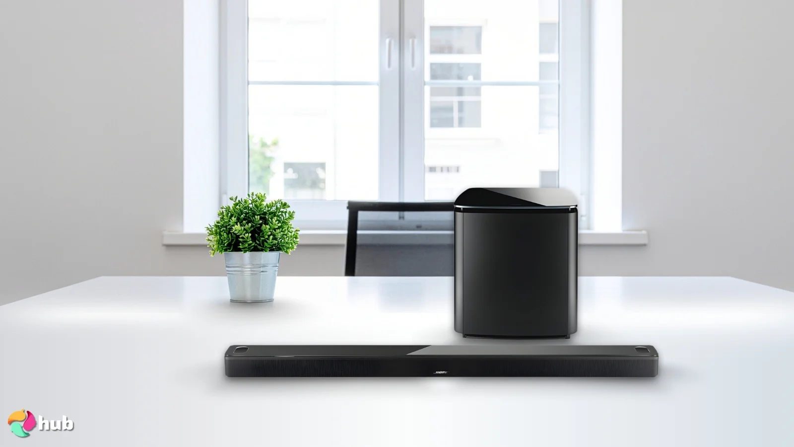 Bose Smart Ultra Soundbar on a white office desk in a minimalist setup for a review