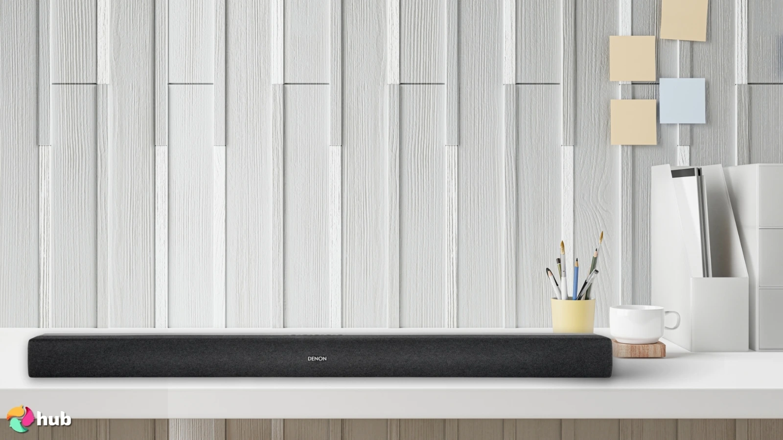 Denon DHT-S218 Soundbar on a white office desk with an editorial style for a review