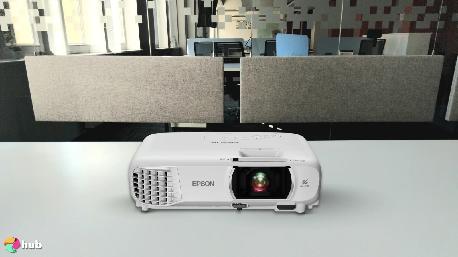 Epson Home Cinema 1100 3-Chip 3LCD Projector on a white office desk in a minimalist setup for a review