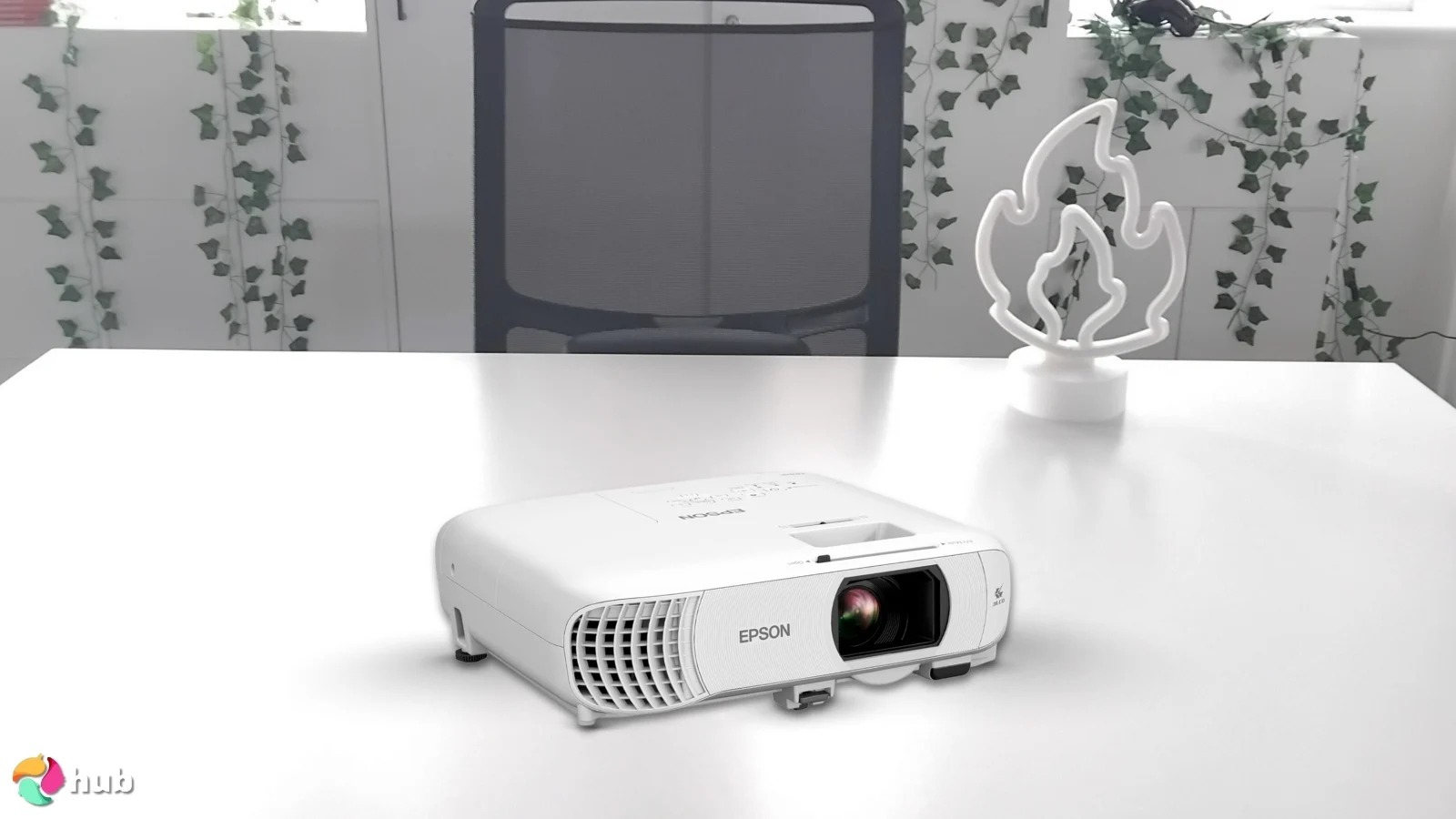 Epson Home Cinema 980 Projector on a white office desk in a well-lit setting for a review