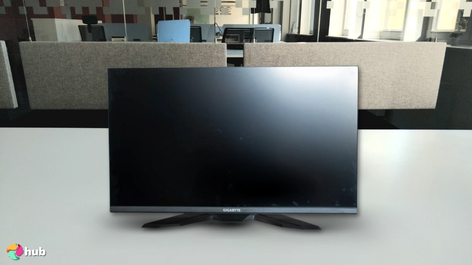 GIGABYTE M32U Gaming Monitor on a white office desk photographed for a review