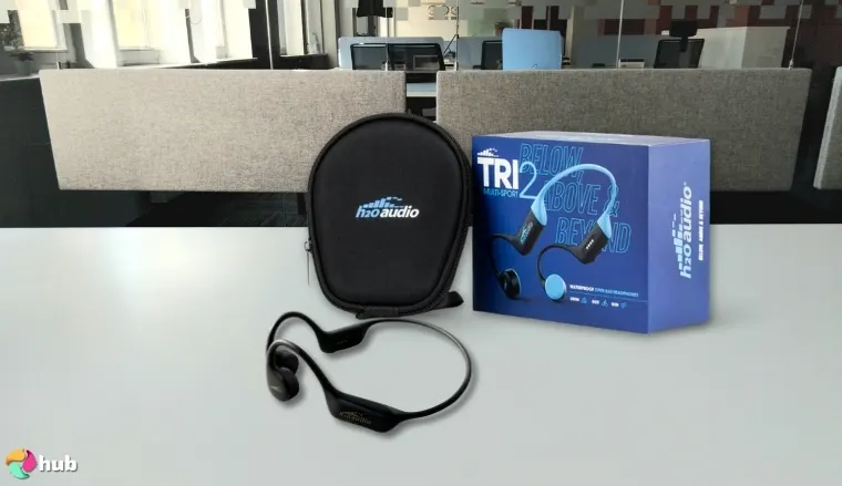 H2O Audio TRI 2 Open-Ear Headphones on a white office desk in a top-down view for a review