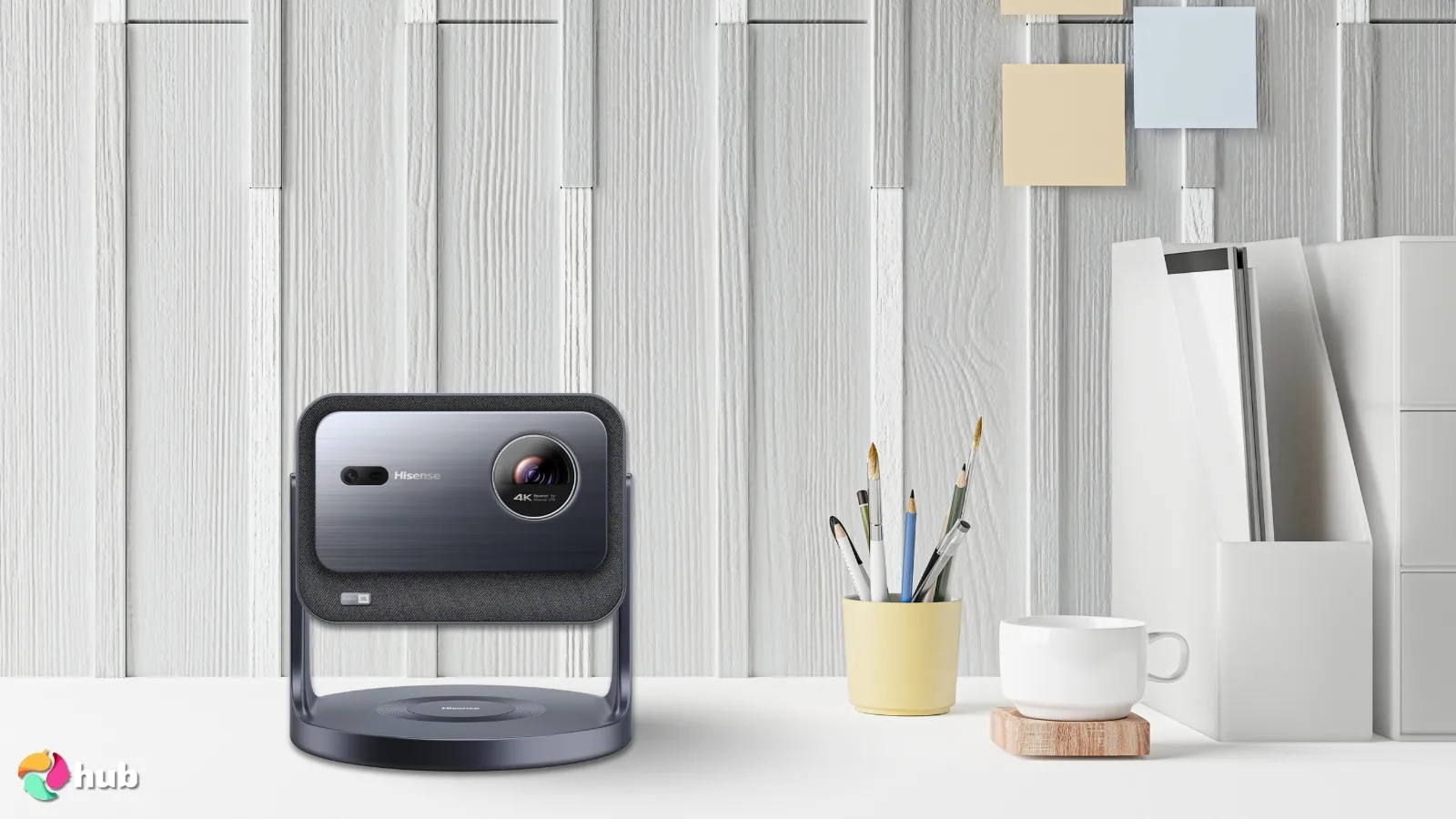 Miniproyector láser Hisense C2 Portable Projector on a white office desk with decorative items for a review