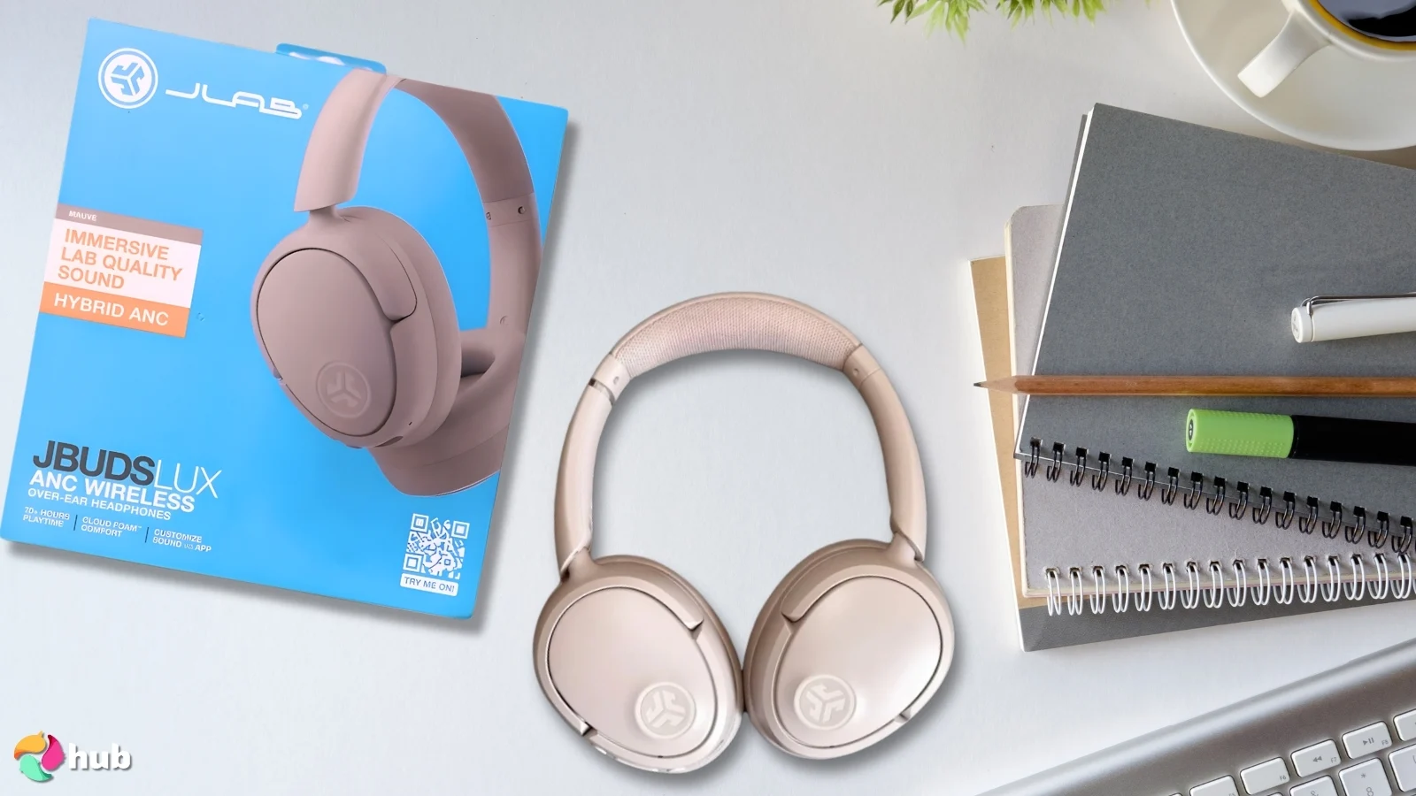 JLab JBuds Lux Headphones on a white office desk in a well-lit setting for a review