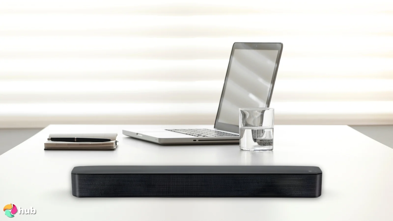 LG SKM1 Soundbar on a white office desk in a top-down view for a review