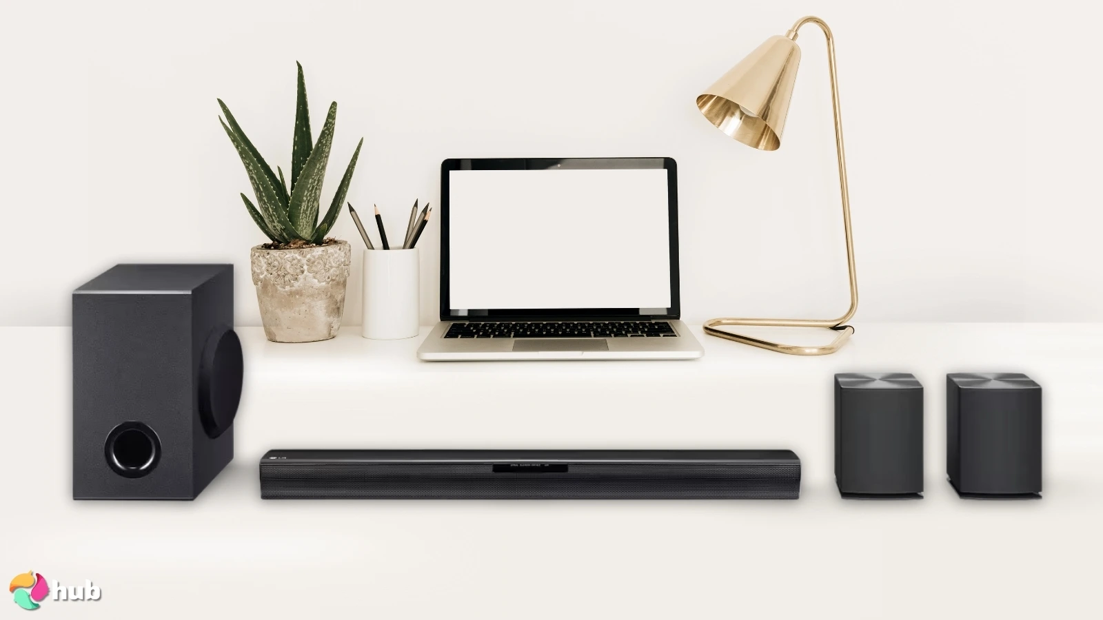 LG SQC4R Soundbar on a white office desk with decorative items for a review