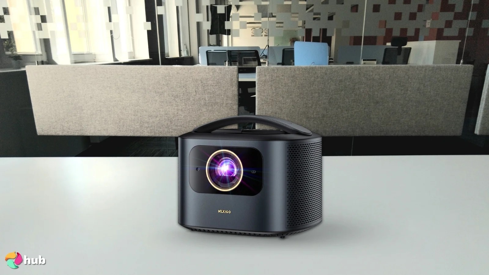 NexiGo TriVision Ultra Portable Projector on a white office desk in a clean setup for a review