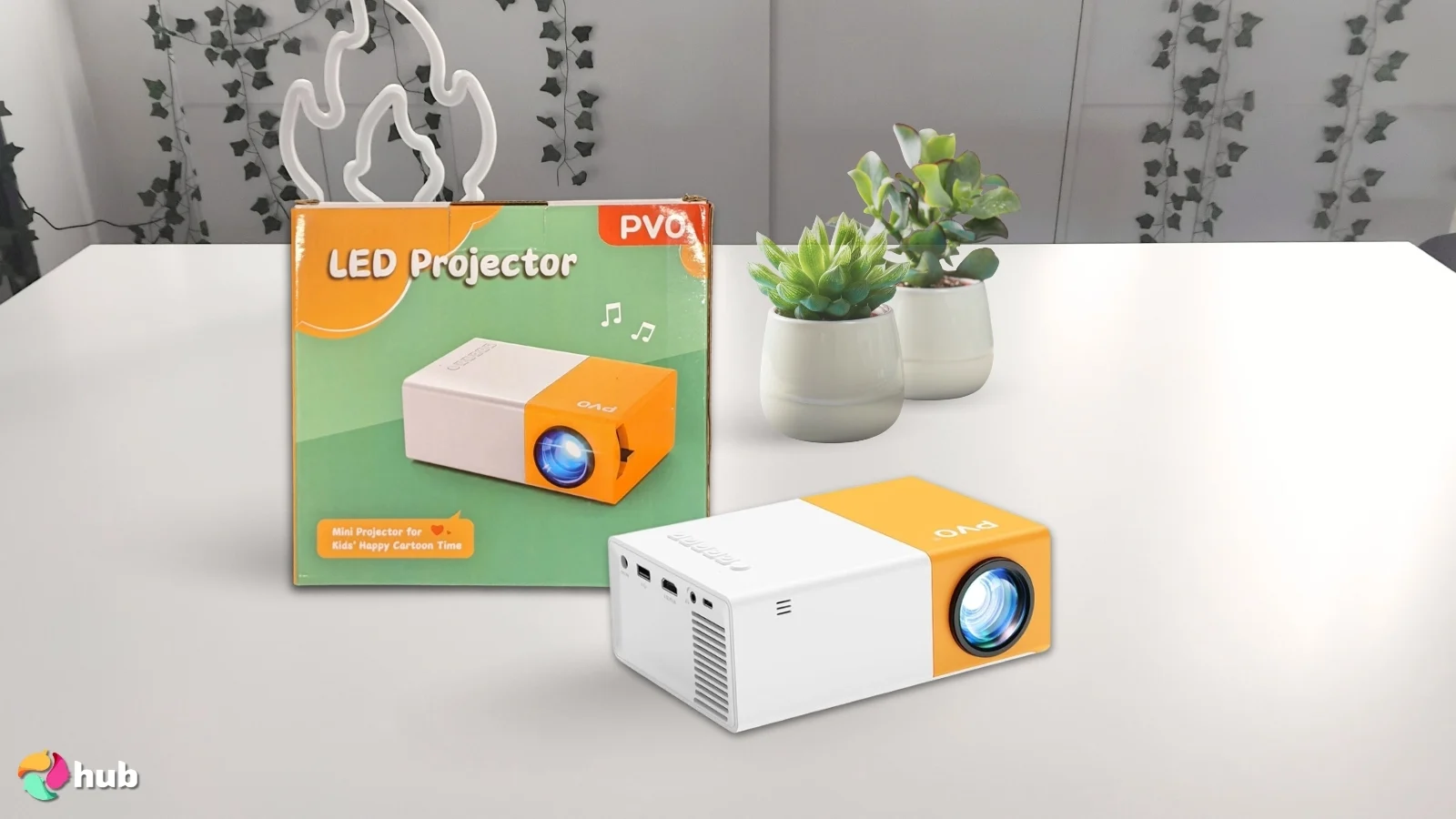 PVO Mini Projector on a white office desk styled neatly for a review