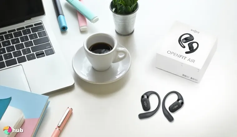 SHOKZ OpenFit Air Running Headphones on a white office desk in a top-down view for a review