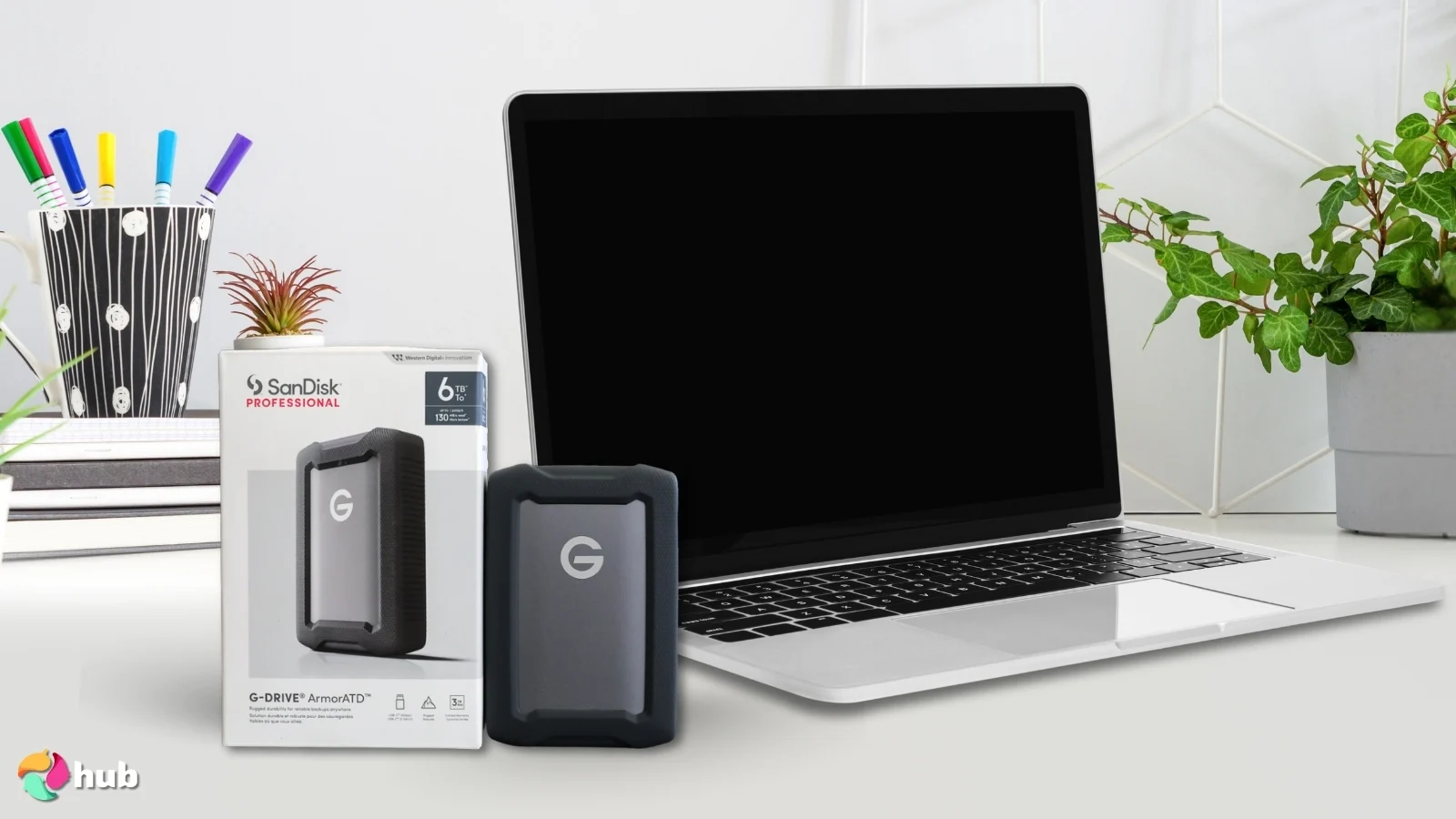 SanDisk Professional ArmorATD External SSD on a white office desk set for a professional product review