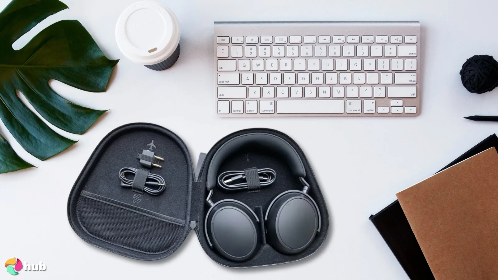 Sennheiser Momentum 4 Headphones on a white office desk with decorative items for a review