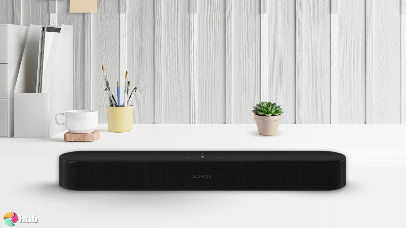 Sonos Beam Gen 2 Soundbar on a white office desk in a clean setup for a review