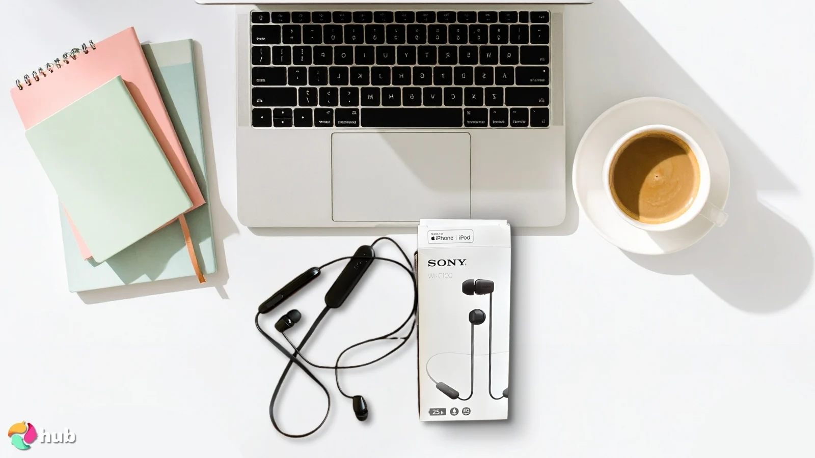 Sony WI-C100 Headphones on a white office desk in a top-down view for a review