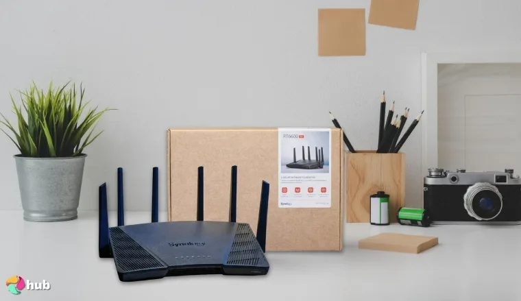 Synology RT6600ax VPN Router on a white office desk styled for promotional review
