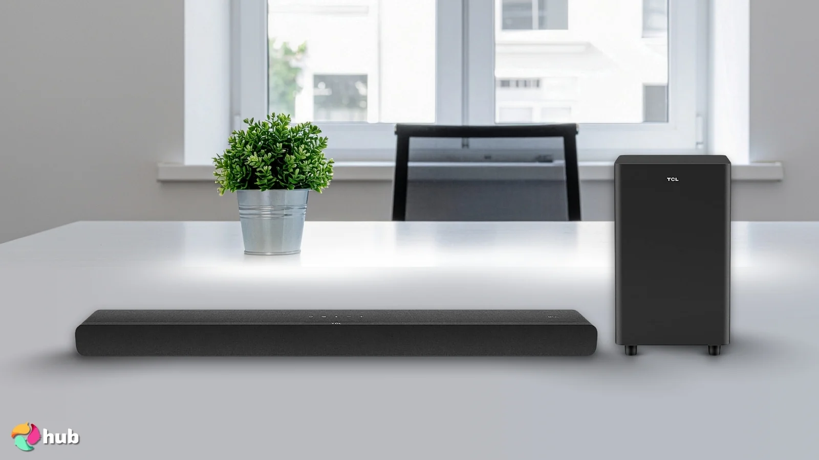 TCL S55H Soundbar on a white office desk with soft lighting for a review