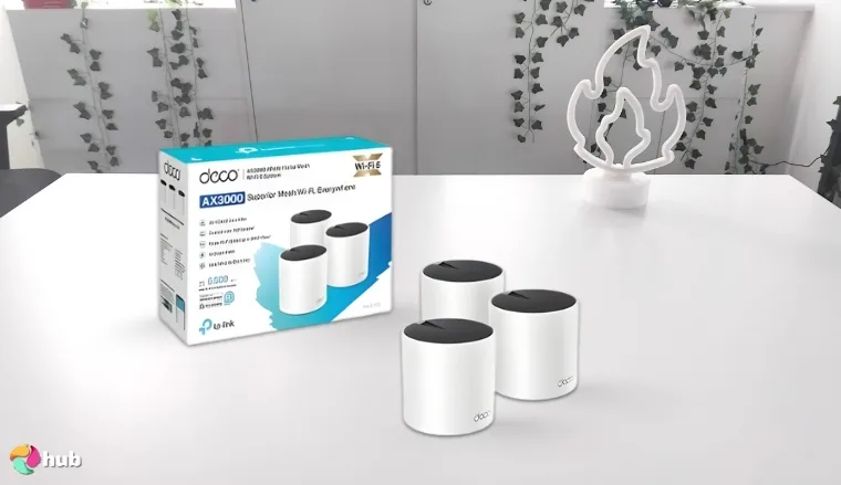 TP-Link Deco X55 Mesh Wi-Fi System on a white office desk in a clean setup for a review