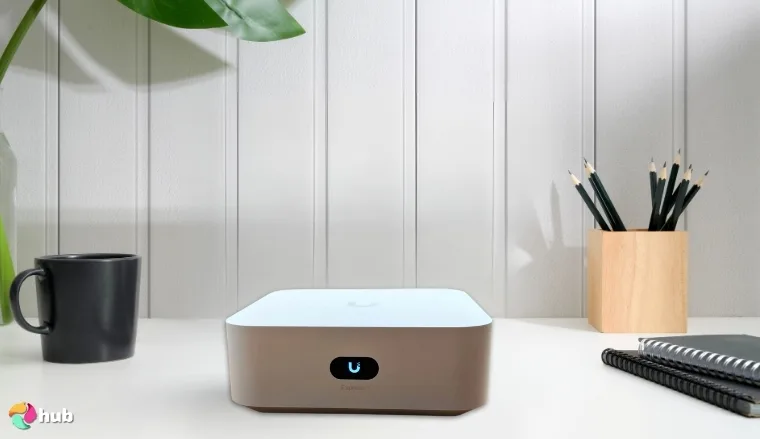 Ubiquiti UniFi Express 7 Mesh Wi-Fi System on a white office desk with soft lighting for a review