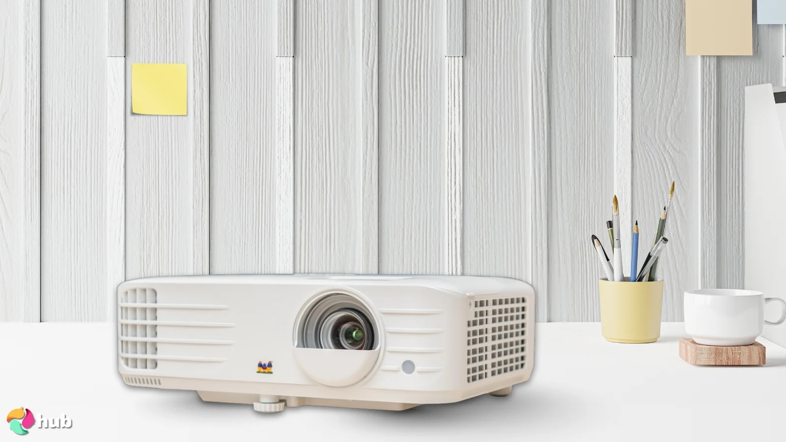 ViewSonic PX701-4K Projector on a white office desk with professional arrangement for a review