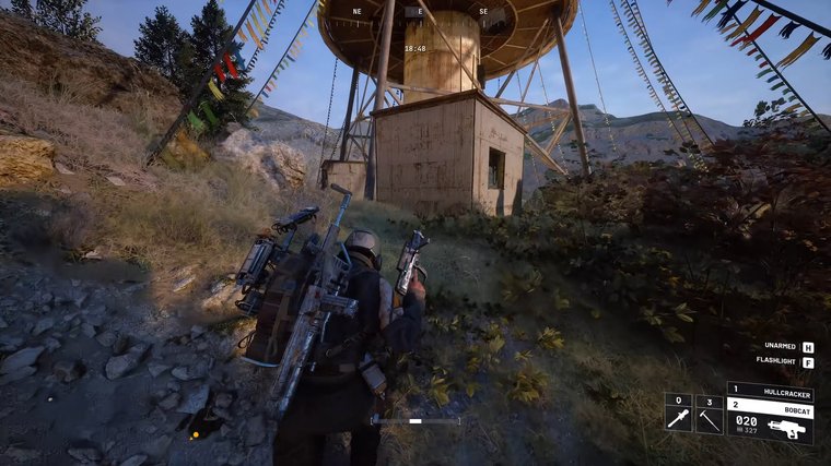 ARC Raiders running up a hill towards a building.