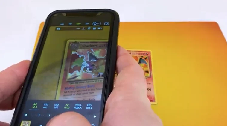 Close-up of a phone as a person records a Pokémon card