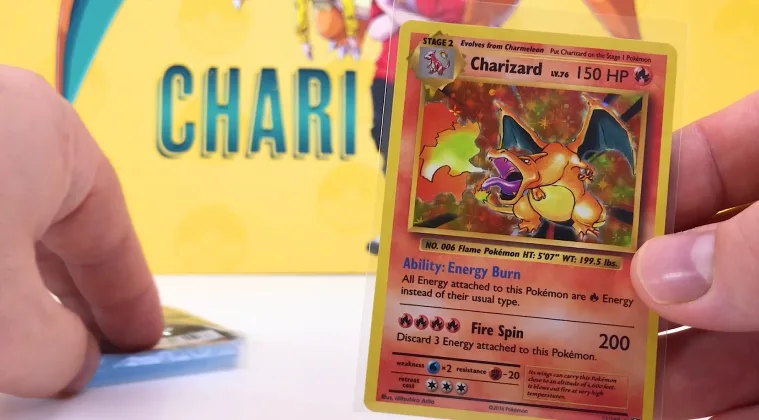 Close-up of a Charizard Pokémon card held in a hand