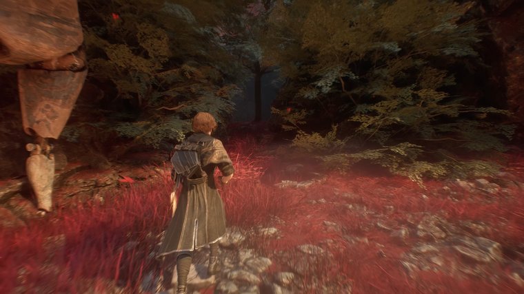 Clair Obscur: Expedition 33 walking in a forest red grass.