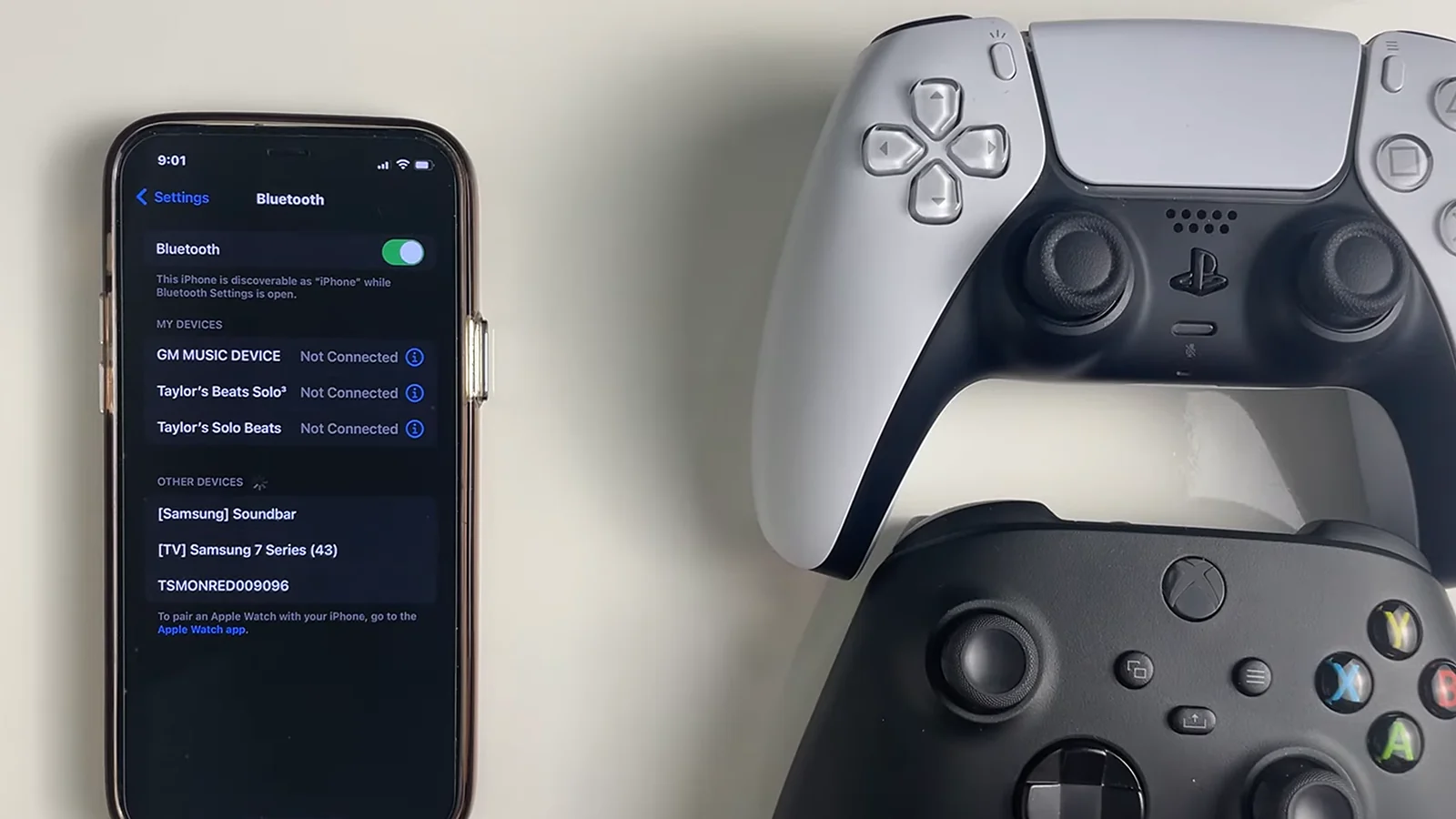 A phone and two controllers at the table