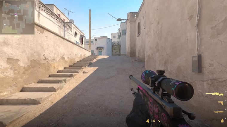 Counter-Strike 2 with a sniper in hands sneaking near a wall.