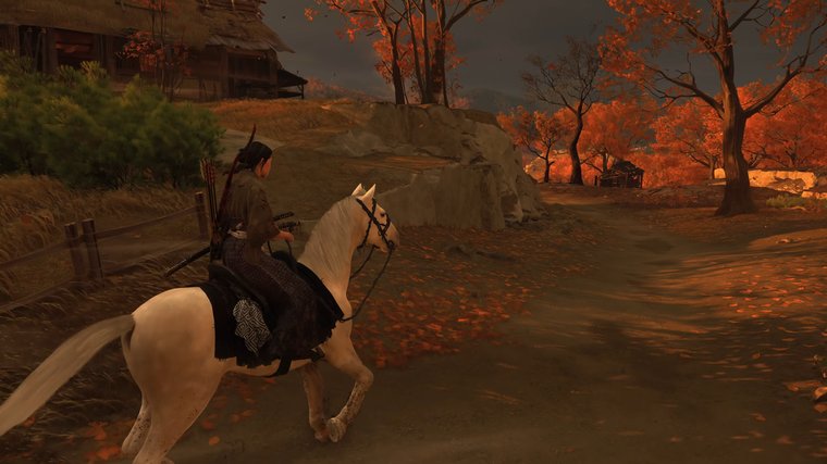 Ghost of Yōtei main character riding on a horse during sunset.