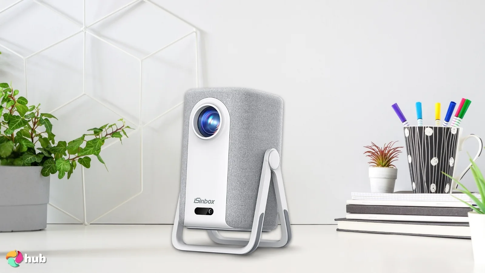 iSinbox Short Throw Portable Projector on a white office desk with creative arrangement for a review